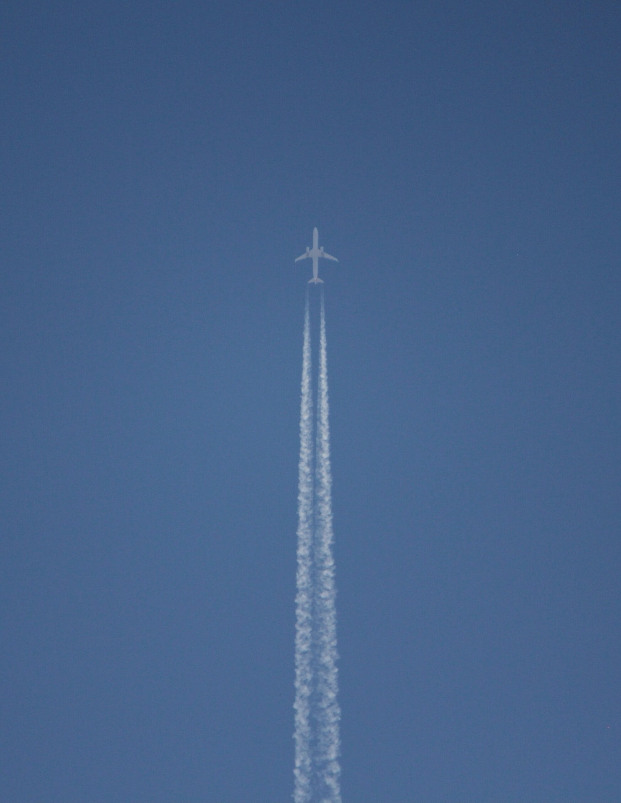 white wind turbine under blue sky